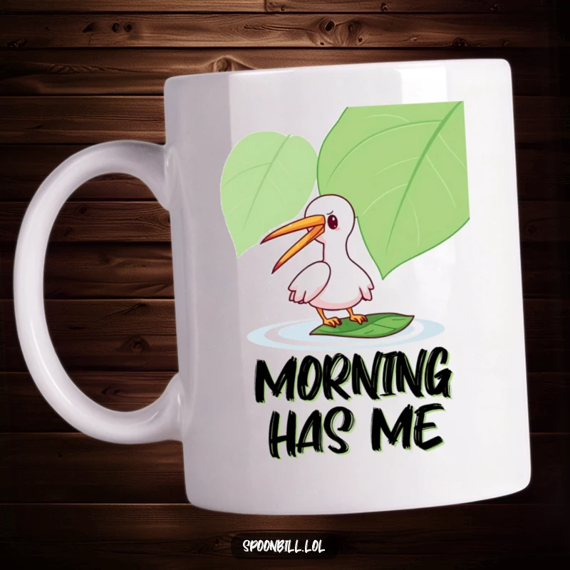 Funny Spoonbill Mug: A playful character with its long beak gently taps a floating leaf, a humorous depiction of lighthearted interaction.